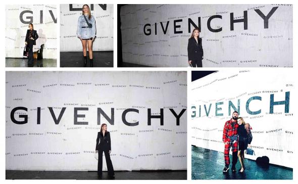 Pose devant un mur d'affichage sauvage du défilé Givenchy